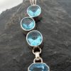 Sterling Silver Journey Pendant with Four Blue Topaz Gemstones