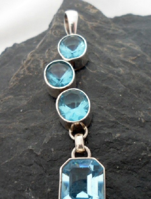 Sterling Silver Journey Pendant with Four Blue Topaz Gemstones