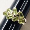 Handcrafted sterling silver ring from Nepal featuring a cluster of genuine bezel-set faceted green Peridot gemstones in a unique artisan design.